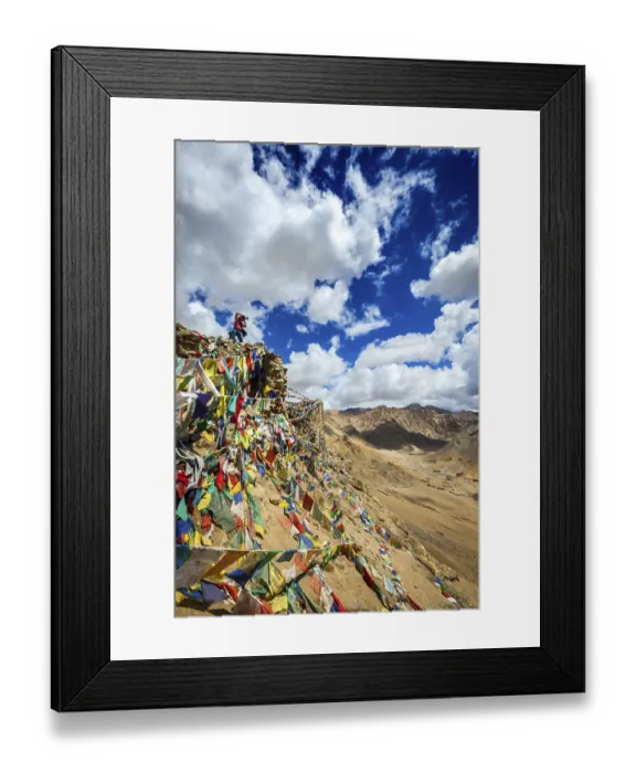 Framed Print : Travel photographer taking photos in Himalayas mountains on cliff with Buddhist prayer flags