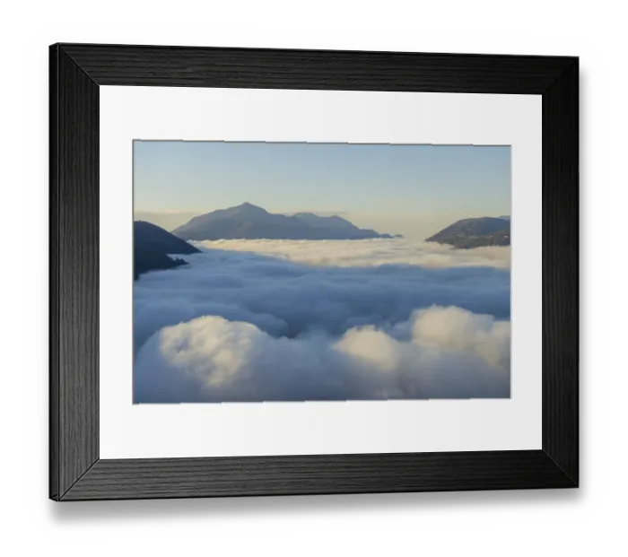 Framed Print : Mountain Peak Above Cloudscape with Sunlight and Clear Sky in Lugano