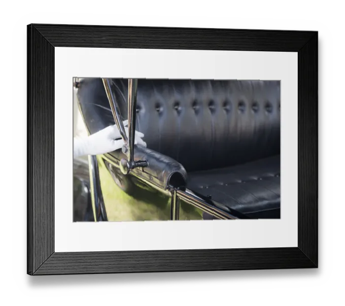 Framed Print : White gloved female hand on leather of antique model T automobile seat