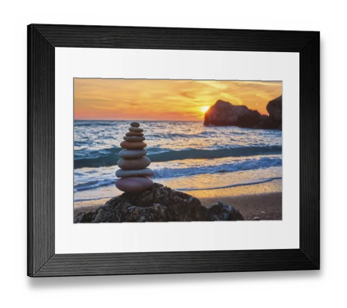 Framed Print : Cairn stack of stones pebbles cairn on the beach coast of the seaon sunset