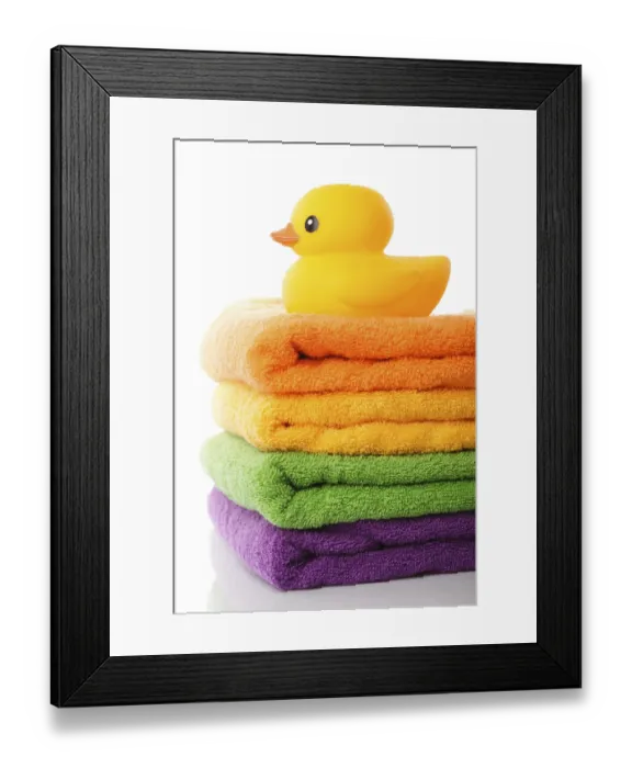 Framed Print : Stack of colorfull towels and yellow rubber duck isolated on white Framed Print : Stack of colorfull towels and yellow rubber duck isolated on white