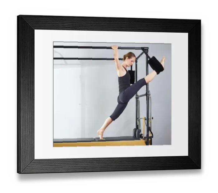 Framed Print : Pilates woman in cadillac split legs stretch exercise at gym Framed Print : Pilates woman in cadillac split legs stretch exercise at gym