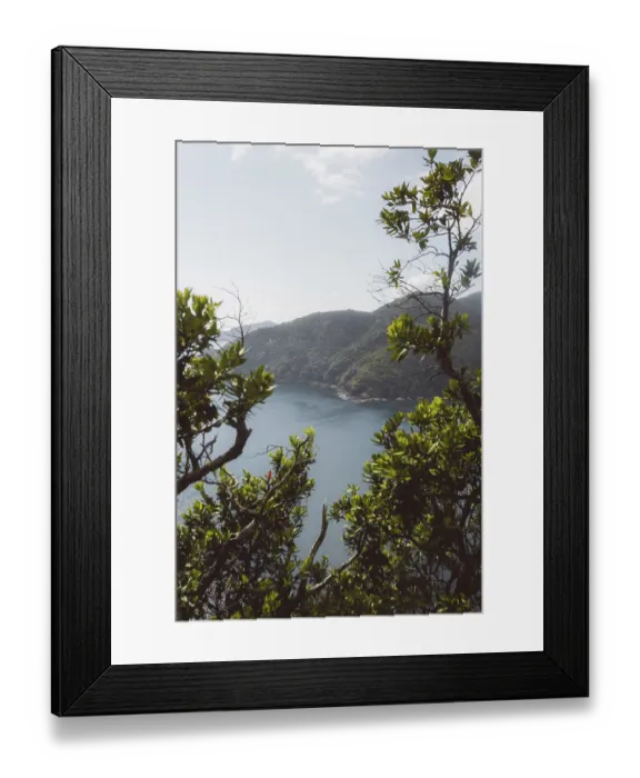 Framed Print : Coastline with lush greenery and views of tranquil sea and mountains