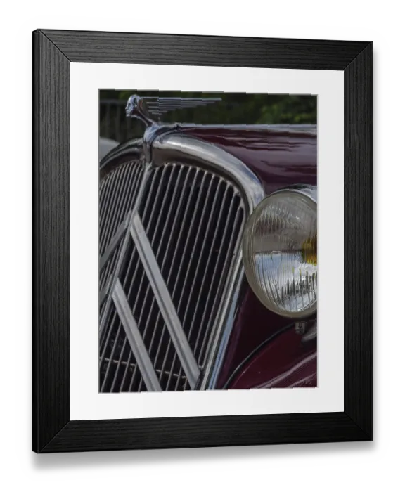 Framed Print : Front view of a red vintage car with striking radiator grille and detailed emblem