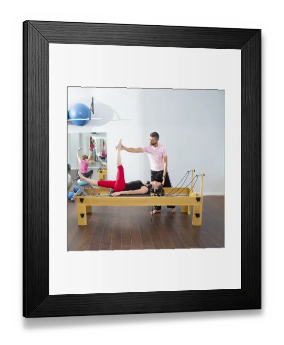 Framed Print : Pilates aerobic personal trainer instructor man in cadillac fitness woman exercise