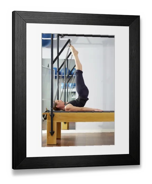 Framed Print : Pilates woman in reformer tower exercise at gym indoor