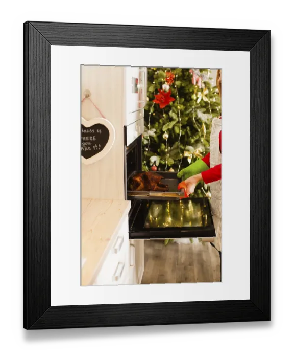 Framed Print : Woman cooking stuffed duck in the kitchen for Christmas party Framed Print : Woman cooking stuffed duck in the kitchen for Christmas party