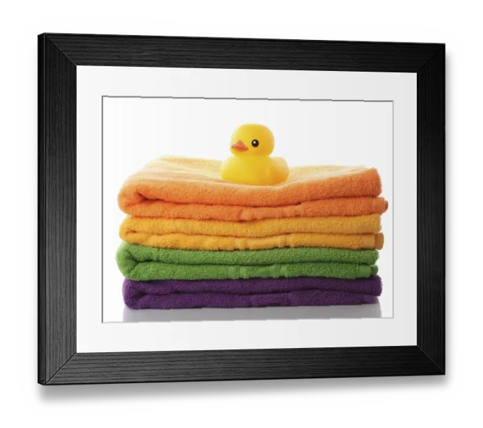 Framed Print : Stack of colorfull towels and yellow rubber duck isolated on white Framed Print : Stack of colorfull towels and yellow rubber duck isolated on white