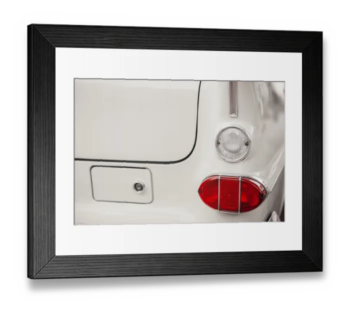Framed Print : Right tail and reversing lights on a white vintage car with chrome trim