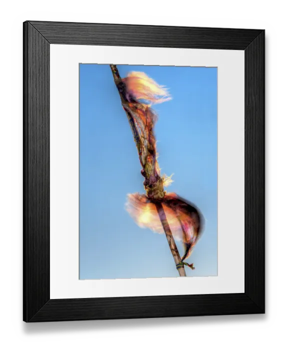 Framed Print : A Buddhist prayer flag flutters in the wind against a blue