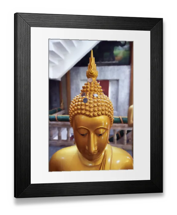 Framed Print : Buddha statue with coins as donation Framed Print : Buddha statue with coins as donation