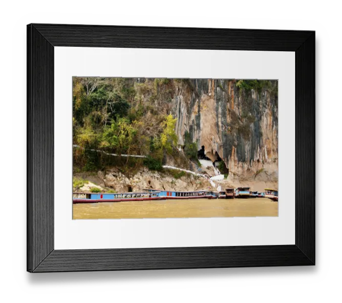 Framed Print : The Pak Ou Caves are upriver from Luang Prabang at the confluence of the Mekong and the Nam Ou rivers
