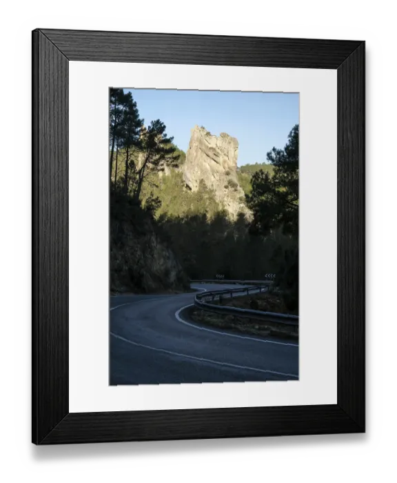 Framed Print : Rock in morning light, country road in the shade