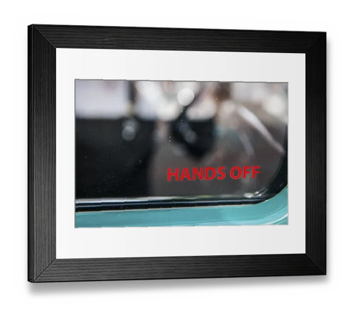 Framed Print : Lateral partial view of the side window of a vintage car with the inscription hands off Framed Print : Lateral partial view of the side window of a vintage car with the inscription hands off