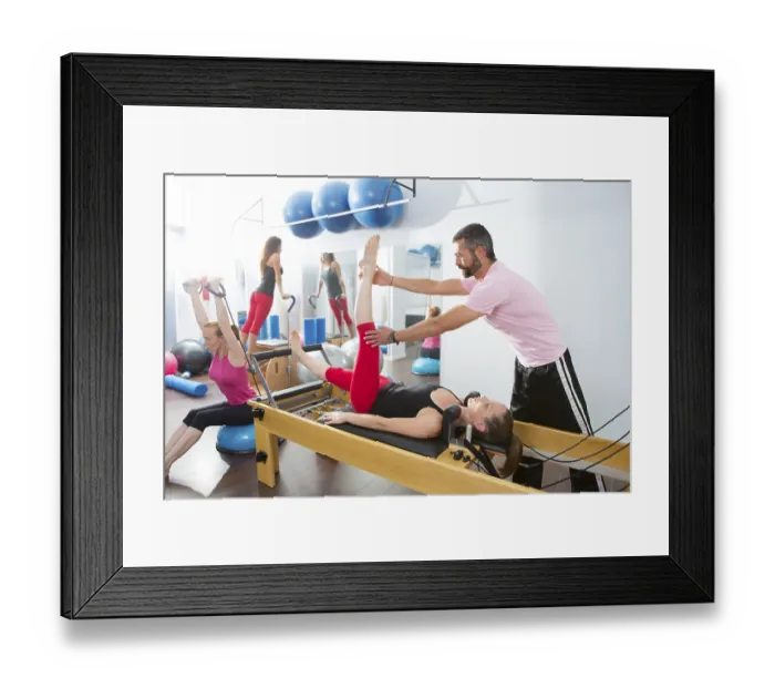 Framed Print : Pilates aerobic personal trainer instructor man in cadillac fitness woman exercise