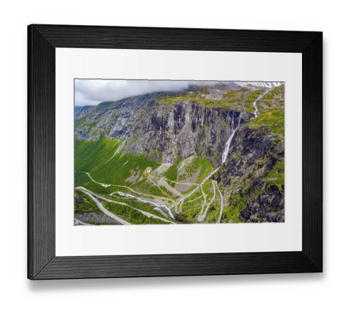 Framed Print : The serpentine road meanders on the green slopes of the canyon