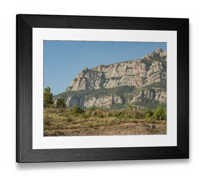 Framed Print : Mountain backdrop with green vegetation and blue sky