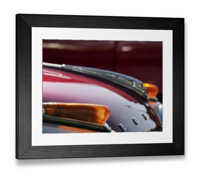 Framed Print : Detail of a vintage car with red paintwork and chrome accents