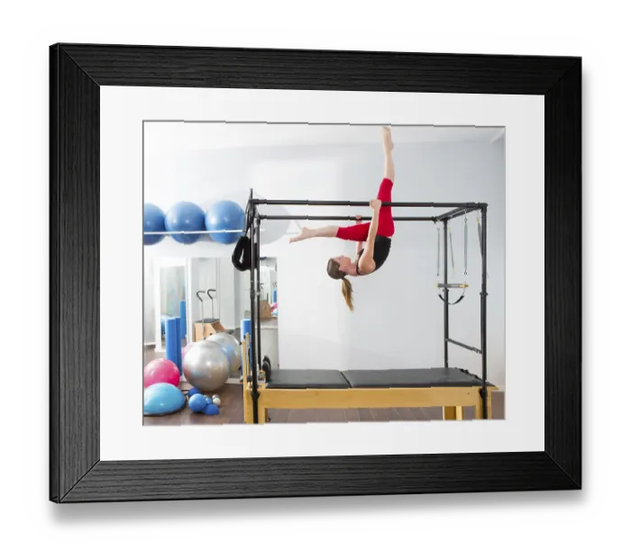 Framed Print : Pilates aerobic instructor woman in cadillac fitness exercise
