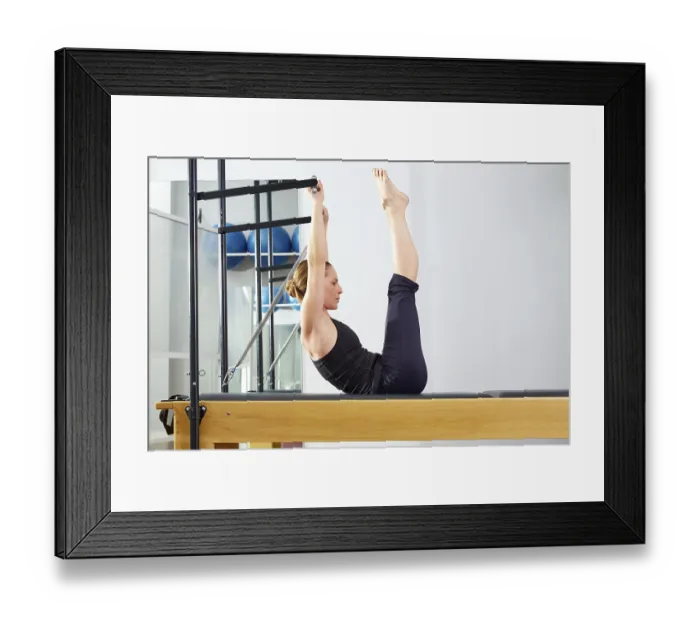 Framed Print : Pilates woman in reformer exercise at gym indoor