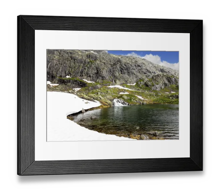 Framed Print : Cold summer in Norway. Large snowfields is reflected in the water of the lake
