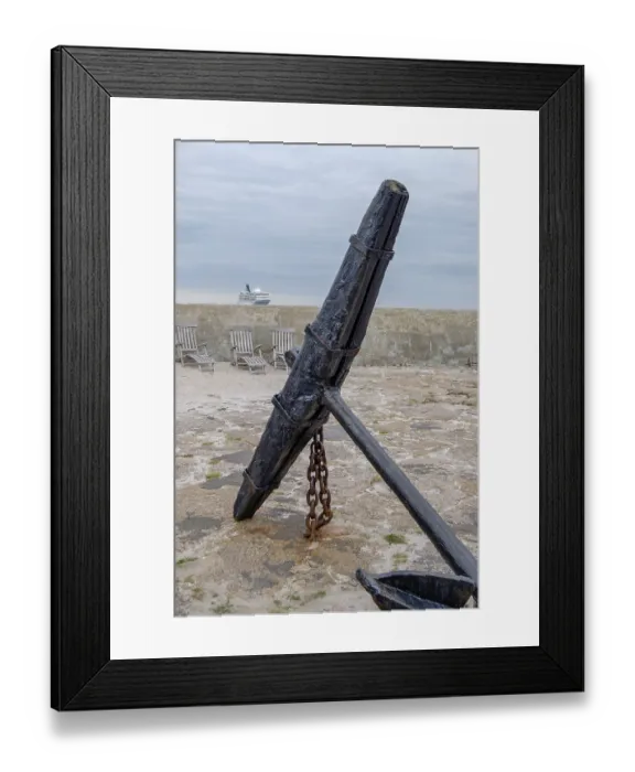 Framed Print : Big old anchor on a rocky coast with a cruise ship on the horizon