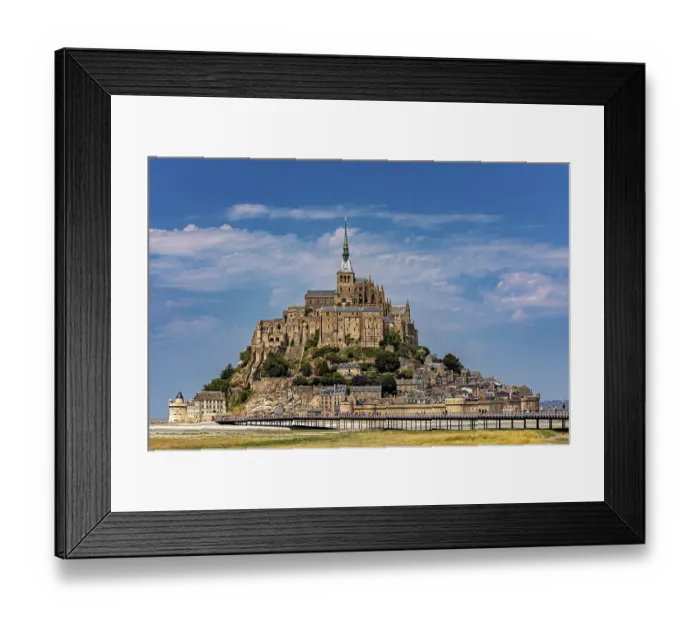 Framed Print : An imposing castle rises against a blue sky with a few clouds Framed Print : An imposing castle rises against a blue sky with a few clouds