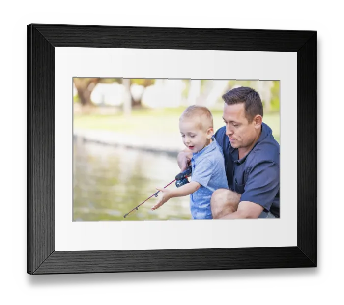 Framed Print : Young caucasian father and son having fun fishing at the lake