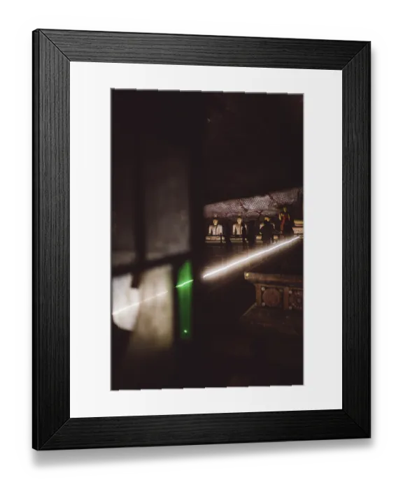 Framed Print : Dark temple room, Buddha statues highlighted by a green ray of light