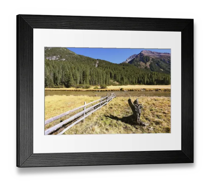 Framed Print : Alpine Valley in Austria. Scenic farm fields blocked by the wooden fence
