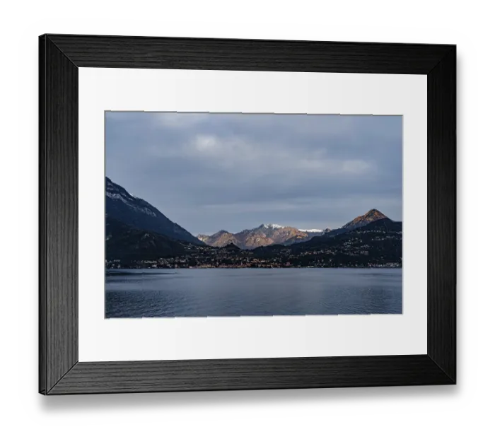 Framed Print : Snow-capped peaks of a mountain range in sunbeams