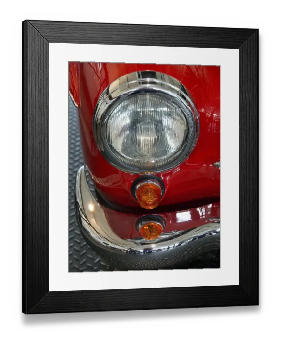 Framed Print : Close-up of a vintage car headlight with red details