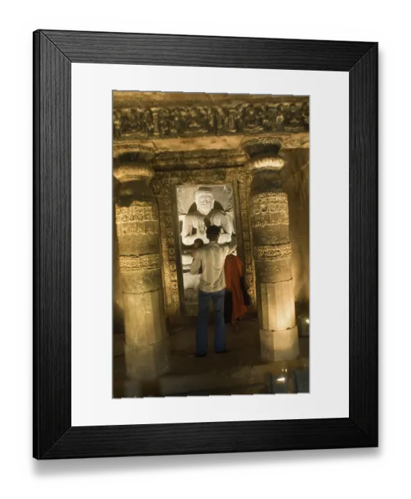 Framed Print : Tourists watching statue of god Buddha in Ajanta caves