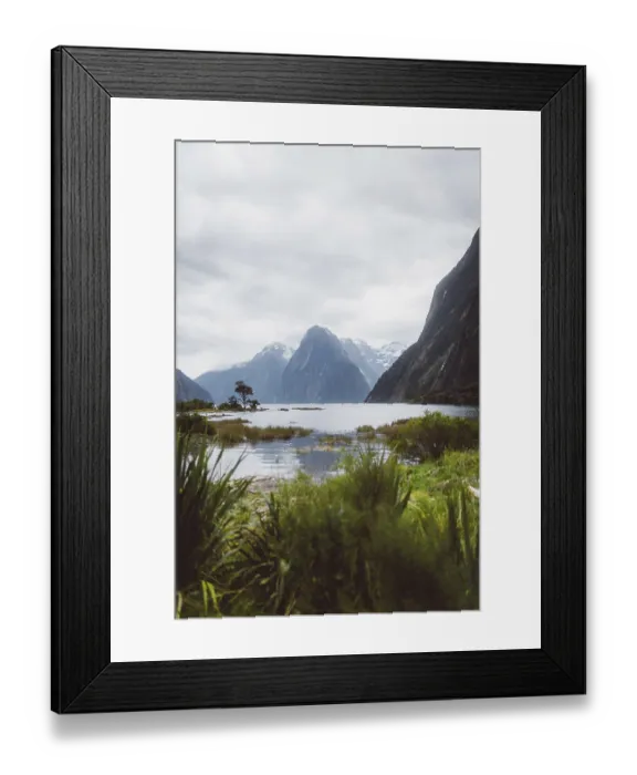 Framed Print : Large lake surrounded by high mountains and green vegetation