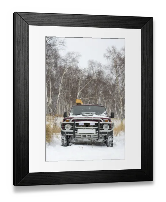Framed Print : Russian off-road four-wheel drive vehicle in winter birch forest while snowing Framed Print : Russian off-road four-wheel drive vehicle in winter birch forest while snowing