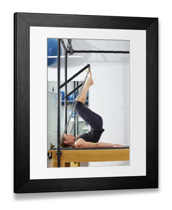 Framed Print : Pilates woman in reformer tower exercise at gym indoor Framed Print : Pilates woman in reformer tower exercise at gym indoor