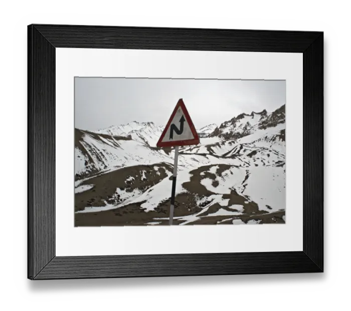 Framed Print : Left reverse bend signboard with Himalayan mountain