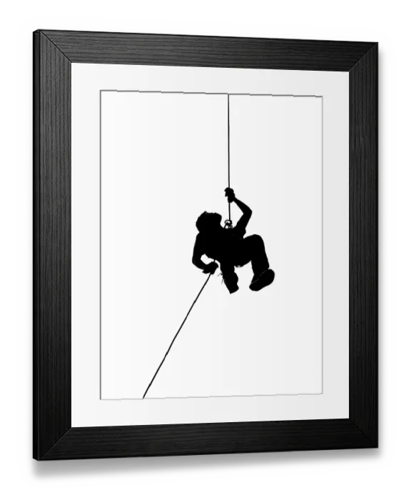 Framed Print : A male climber rappels downward on a rope Framed Print : A male climber rappels downward on a rope