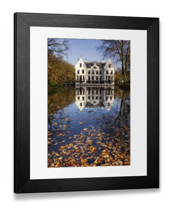 Framed Print : Castle Staverden on the Dutch nature area Veluwe reflecting in the moat and surrounded by autumn colored trees