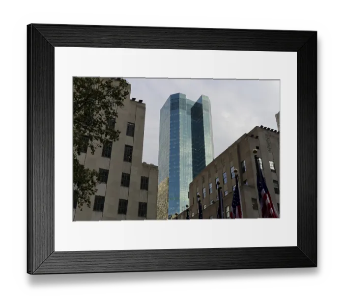 Framed Print : Modern glass building amidst older architecture under a grey sky