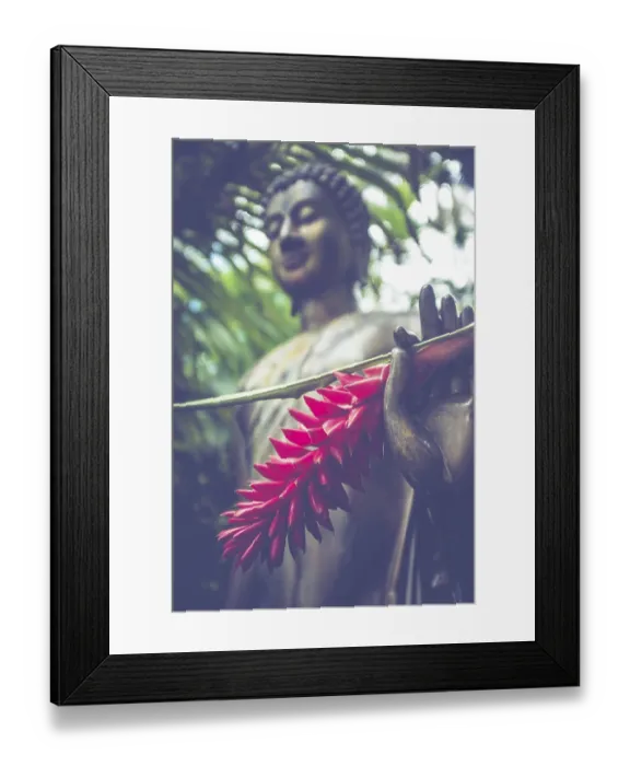Framed Print : Jungle Buddha Statue With A Red Ginger Flower In His Hand