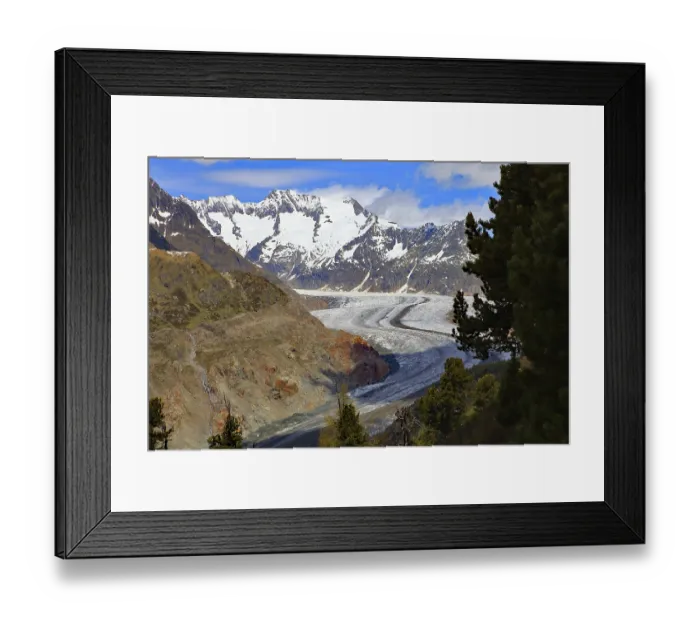 Framed Print : A glacier embedded in a mountain landscape with snow-covered peaks and trees Framed Print : A glacier embedded in a mountain landscape with snow-covered peaks and trees