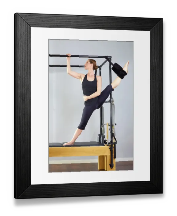 Framed Print : Pilates woman in cadillac split legs stretch exercise at gym Framed Print : Pilates woman in cadillac split legs stretch exercise at gym