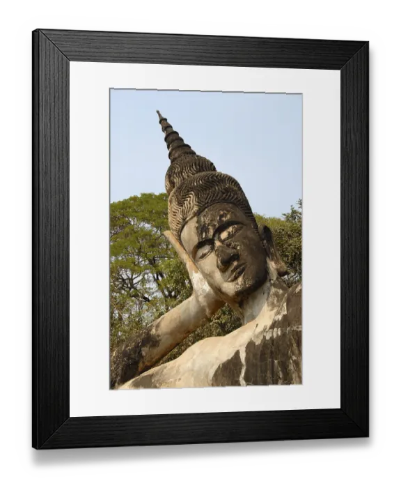 Framed Print : Statue of a reclining buddha leaning on his hand Framed Print : Statue of a reclining buddha leaning on his hand