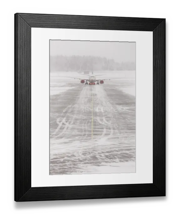 Framed Print : Airplane in bad weather, snow storm on snowy runway Framed Print : Airplane in bad weather, snow storm on snowy runway
