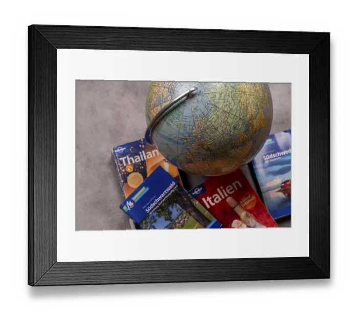 Framed Print : An old-fashioned globe next to travel guides for Thailand Framed Print : An old-fashioned globe next to travel guides for Thailand