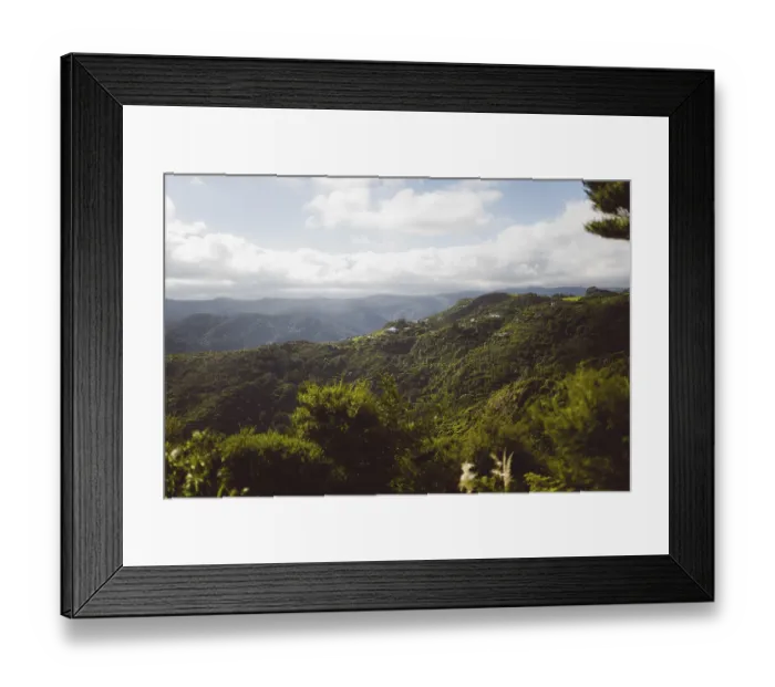 Framed Print : Panoramic shot of green mountains with deep valleys on a cloudy day under a blue sky