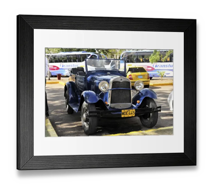 Framed Print : A blue vintage car parked under the sun with its licence plate visible