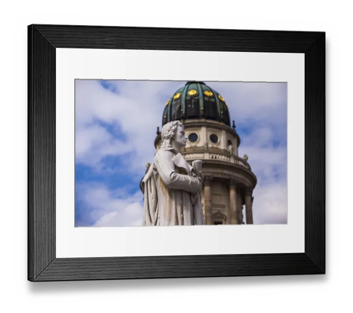 Framed Print : Profile shot of the Schiller statue with the French cathedral in the background