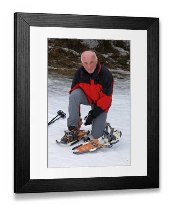 Framed Print : Elderly man hiking in winter with snow shoes Framed Print : Elderly man hiking in winter with snow shoes
